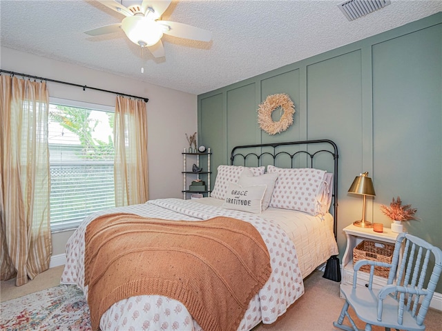 bedroom with carpet flooring, a textured ceiling, and ceiling fan