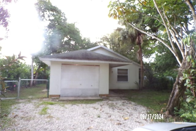 exterior space featuring an outbuilding and a garage