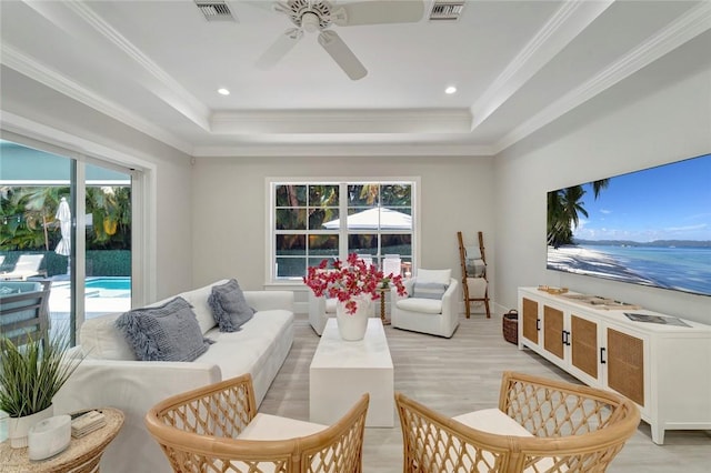 1618 W Sandpointe Pl, Vero Beach, FL 32963 - living area with ceiling fan, a raised ceiling, light wood finished floors, crown molding, and recessed lighting