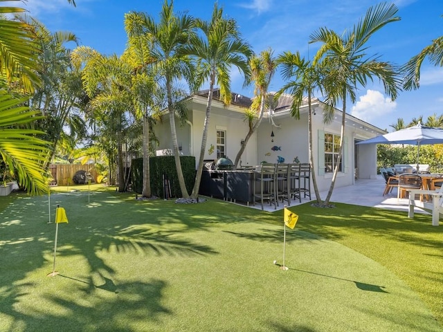 1618 W Sandpointe Pl, Vero Beach, FL 32963 - view of yard with an area to practice putting, a patio, and an outdoor bar