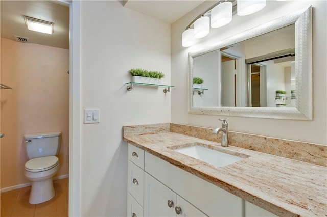 bathroom featuring vanity, tile patterned floors, toilet, and visible vents