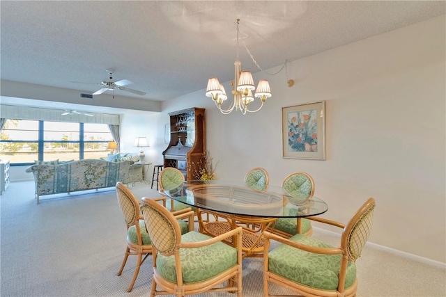 dining area with carpet, baseboards, visible vents, a textured ceiling, and ceiling fan with notable chandelier