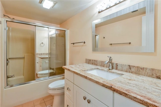 full bath featuring visible vents, toilet, combined bath / shower with glass door, tile patterned flooring, and vanity