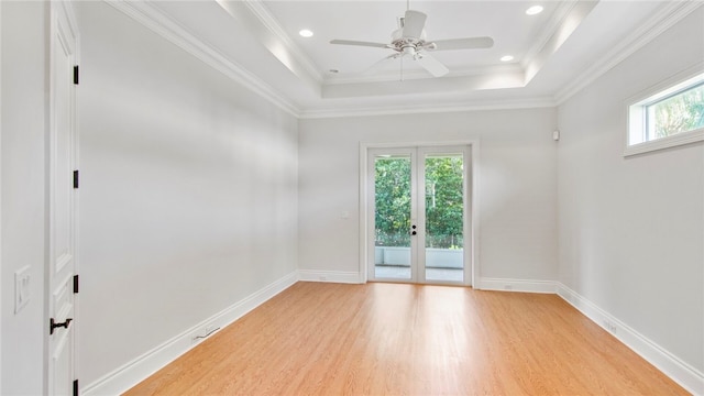 empty room featuring crown molding, plenty of natural light, and light hardwood / wood-style flooring