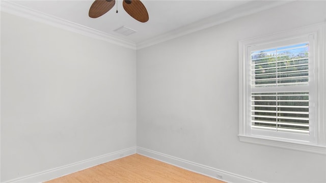 empty room with hardwood / wood-style floors, ceiling fan, and crown molding