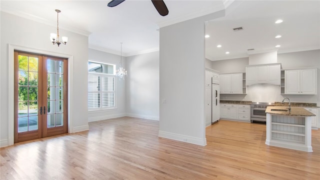 kitchen with white cabinetry, light hardwood / wood-style flooring, and pendant lighting