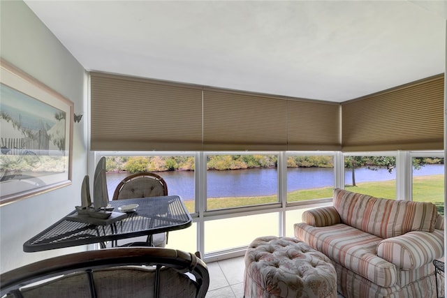 sunroom featuring a water view