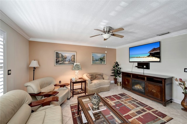 tiled living room with a textured ceiling, ceiling fan, and crown molding