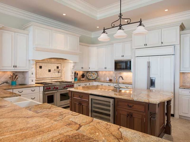 kitchen with white cabinetry, hanging light fixtures, black microwave, wine cooler, and range with two ovens