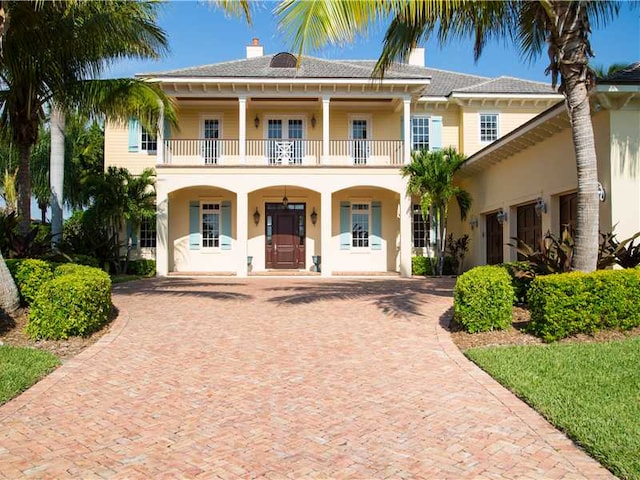 view of front of property with a balcony and covered porch