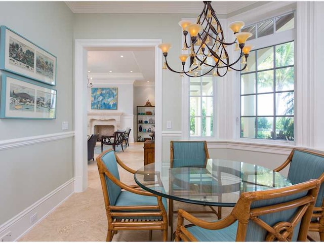 dining space featuring crown molding and a notable chandelier