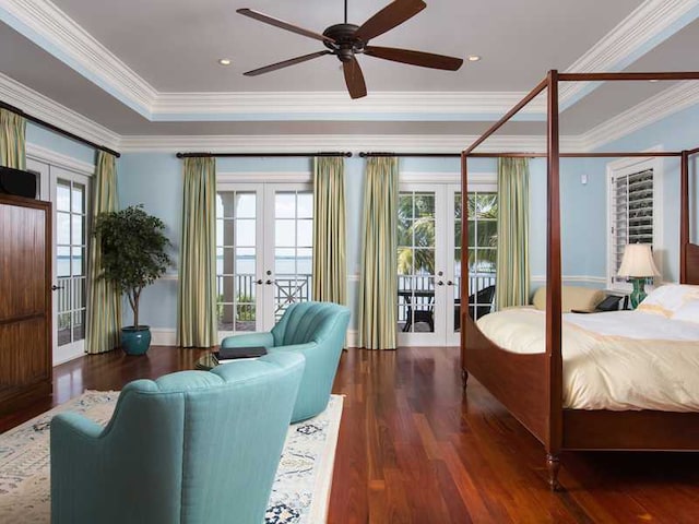 bedroom featuring french doors, dark wood-type flooring, access to outside, ornamental molding, and a raised ceiling