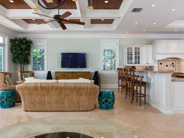 living room with beamed ceiling, ornamental molding, and coffered ceiling