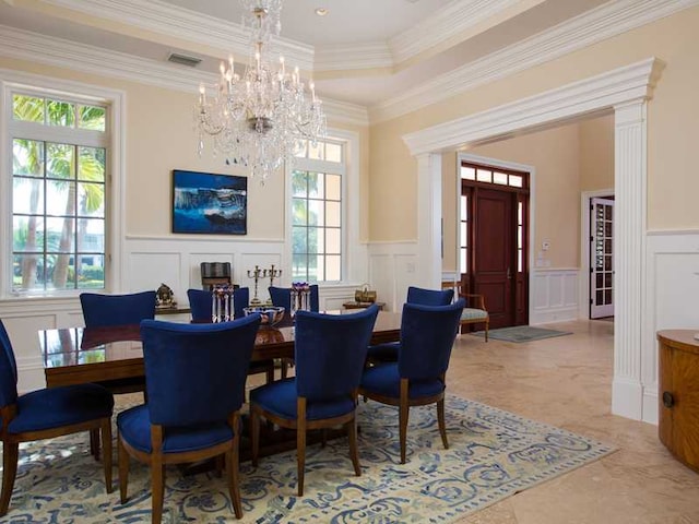 dining area featuring crown molding, a raised ceiling, and a chandelier