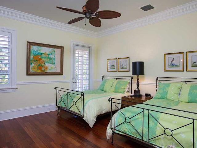 bedroom featuring dark wood-type flooring, ornamental molding, and multiple windows