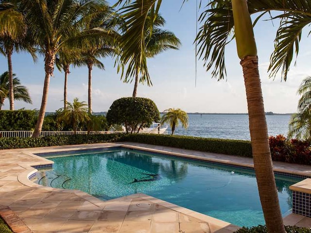 view of pool featuring a patio and a water view