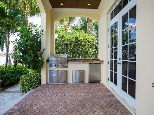 view of patio / terrace with french doors, area for grilling, exterior kitchen, and sink