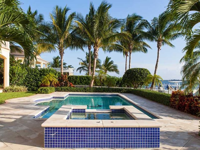 view of pool with an in ground hot tub and a patio area