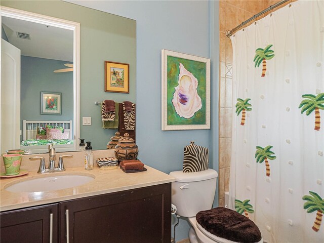 full bathroom with shower / bath combo, vanity, and toilet