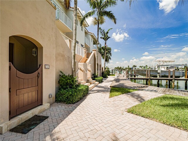 surrounding community featuring a water view and a boat dock