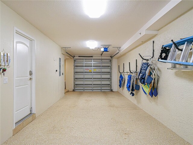 garage with electric panel and a garage door opener