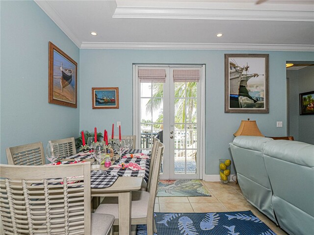 tiled dining area featuring ornamental molding and french doors