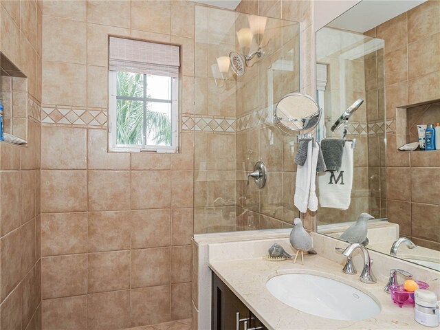 bathroom featuring vanity and tiled shower