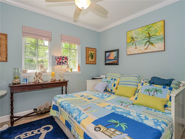 bedroom with ceiling fan and crown molding