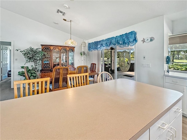 dining room featuring visible vents and lofted ceiling