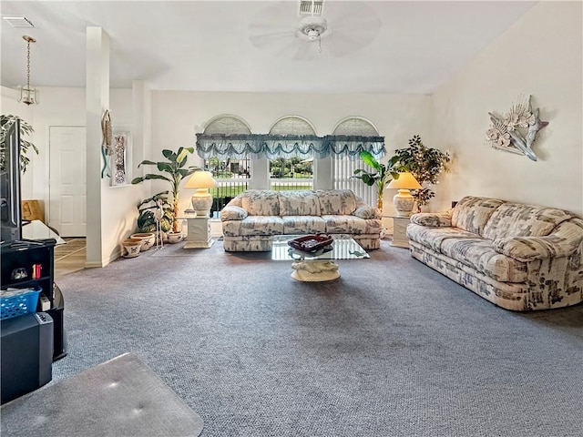 carpeted living area featuring ceiling fan and visible vents