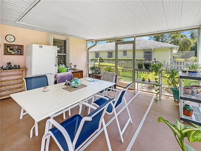 sunroom / solarium with outdoor dining area