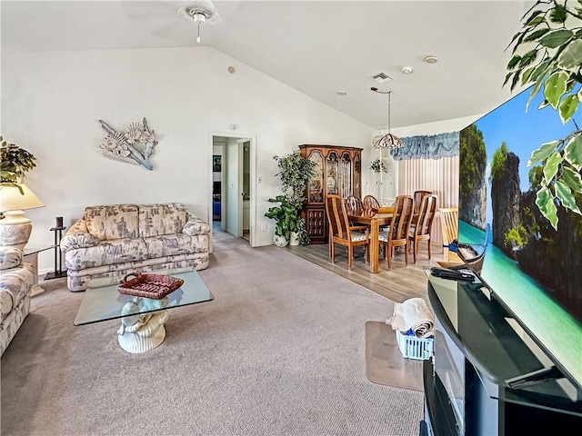 living room with baseboards, visible vents, ceiling fan, and lofted ceiling