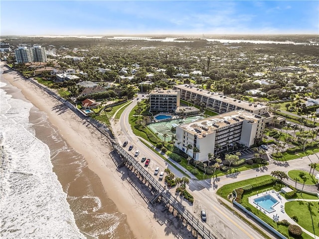 aerial view with a water view and a beach view