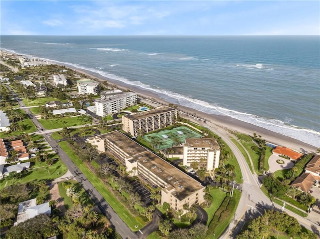 drone / aerial view featuring a water view and a view of the beach