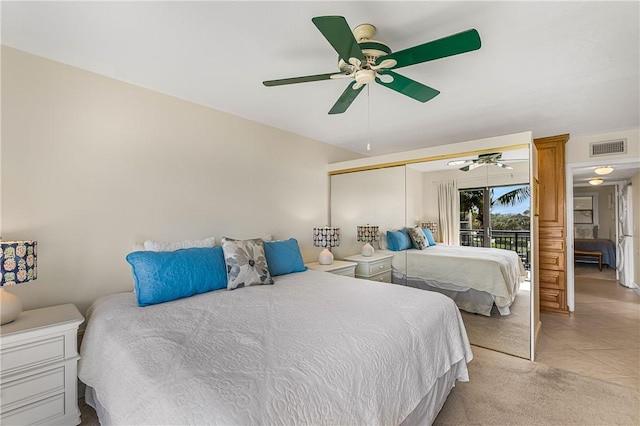 bedroom featuring ceiling fan, a closet, and light tile patterned floors