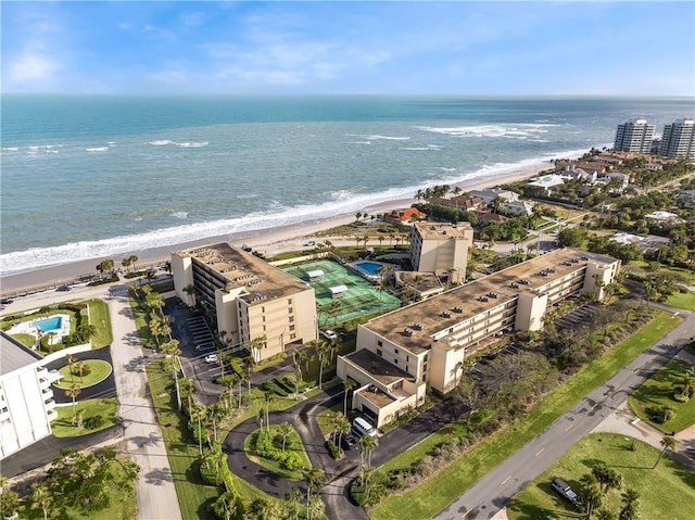 drone / aerial view featuring a beach view and a water view