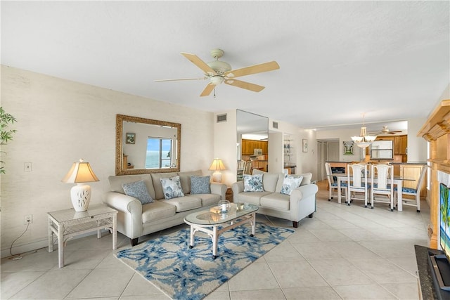 tiled living room featuring ceiling fan