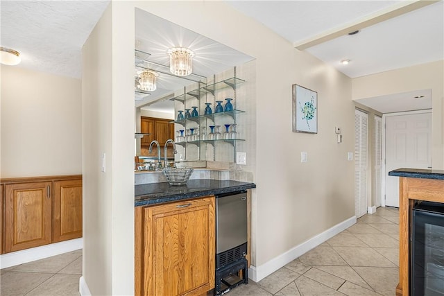 bar with wine cooler, light tile patterned floors, and stainless steel dishwasher