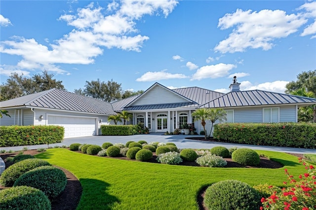 view of front of house featuring a garage and a front lawn