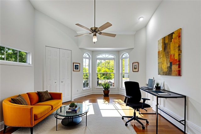 home office featuring a wealth of natural light, high vaulted ceiling, and wood-type flooring