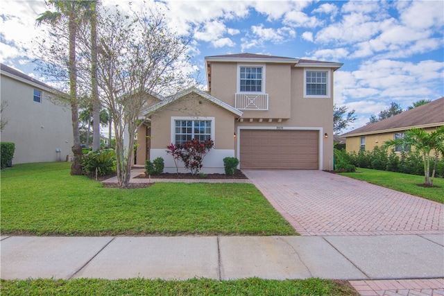 view of property with a garage and a front lawn