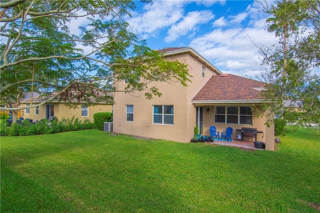 back of property featuring central AC, a patio, and a lawn