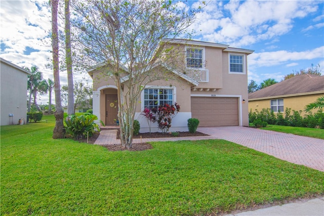 view of front property featuring a garage and a front lawn