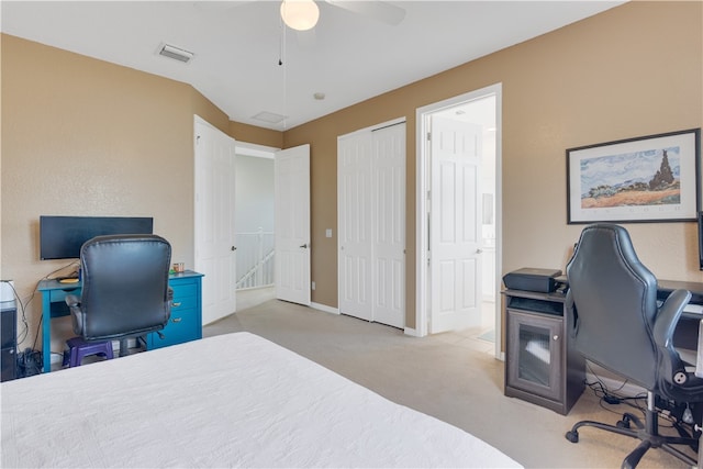 carpeted bedroom with ceiling fan and a closet