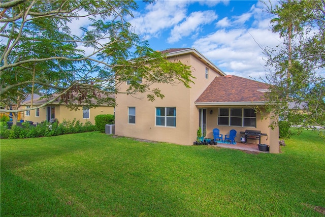 back of house with a lawn, cooling unit, and a patio area