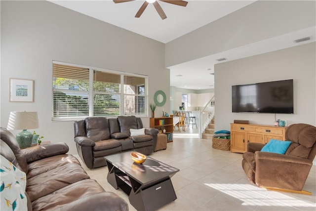 tiled living room featuring ceiling fan