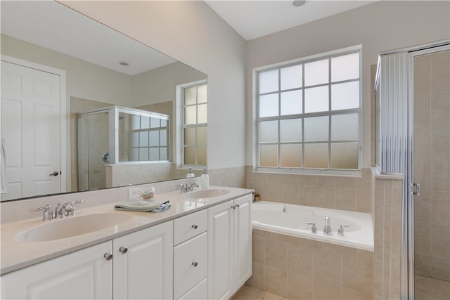 bathroom with independent shower and bath and vanity