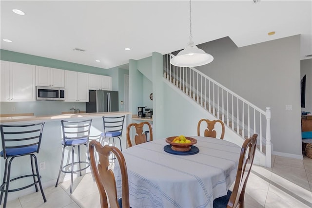 dining area featuring light tile patterned floors