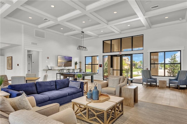 living room with beam ceiling, a towering ceiling, and billiards