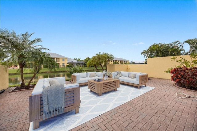 view of patio featuring an outdoor living space and a water view